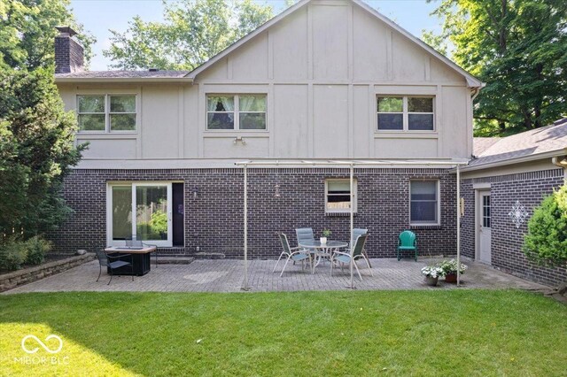 54 Horseshoe Ln, Carmel, IN 46033 - back of property with a chimney, a lawn, board and batten siding, brick siding, and a patio area