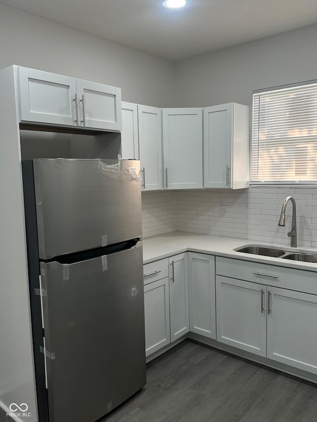 2127 Haines Ave, Indianapolis, IN 46221 - kitchen featuring freestanding refrigerator, dark wood-style flooring, tasteful backsplash, light countertops, and white cabinets