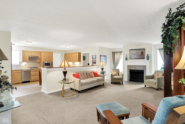 8038 Sydney Ln, Avon, IN 46123 - living room with healthy amount of natural light, a textured ceiling, a tile fireplace, and light colored carpet