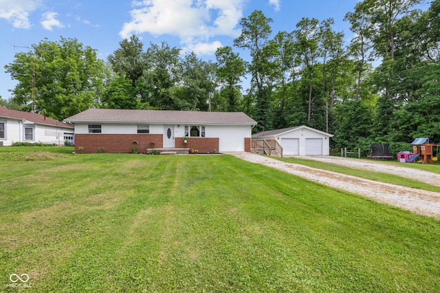 405 W Jacob St, Greencastle, IN 46135 - ranch-style house featuring brick siding, a detached garage, an outbuilding, a front lawn, and a playground
