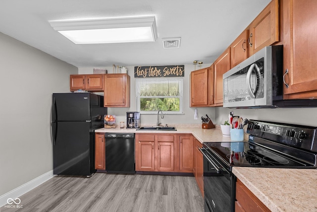 405 W Jacob St, Greencastle, IN 46135 - kitchen with black appliances, brown cabinets, and light countertops