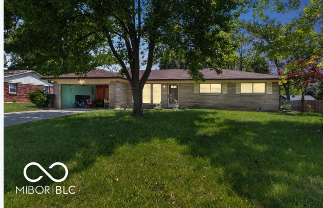 8217 S Talbott Ave, Indianapolis, IN 46227 - ranch-style home featuring asphalt driveway, a garage, and a front yard
