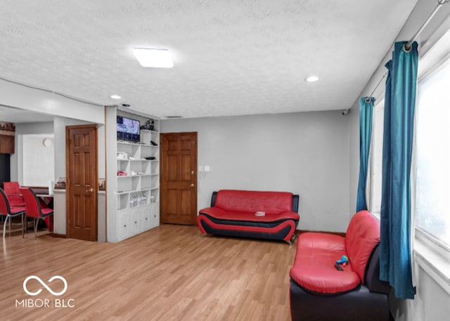 8217 S Talbott Ave, Indianapolis, IN 46227 - sitting room featuring wood finished floors, a textured ceiling, and recessed lighting