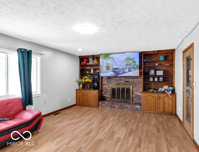 8217 S Talbott Ave, Indianapolis, IN 46227 - living room with a textured ceiling, wood finished floors, and a fireplace