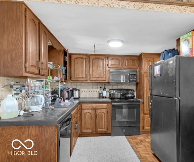8217 S Talbott Ave, Indianapolis, IN 46227 - kitchen featuring black appliances, brown cabinets, decorative backsplash, and dark countertops