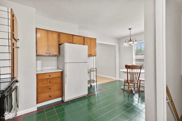 1020 N Ritter Ave, Indianapolis, IN 46219 - kitchen with freestanding refrigerator, electric range, a chandelier, brown cabinets, and light countertops
