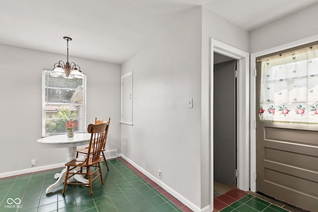 1020 N Ritter Ave, Indianapolis, IN 46219 - dining area featuring dark tile patterned floors and a chandelier
