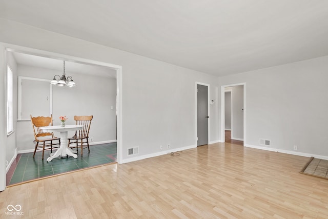 1020 N Ritter Ave, Indianapolis, IN 46219 - dining room featuring wood finished floors and a chandelier