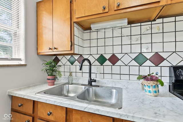 1020 N Ritter Ave, Indianapolis, IN 46219 - kitchen featuring decorative backsplash and brown cabinets