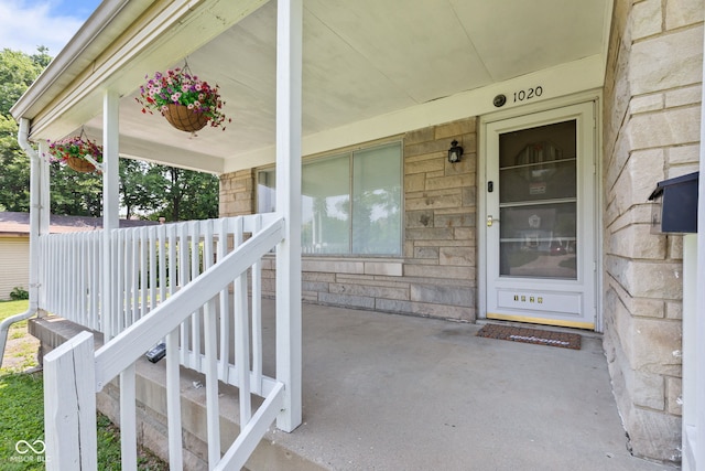1020 N Ritter Ave, Indianapolis, IN 46219 - property entrance featuring a porch and stone siding