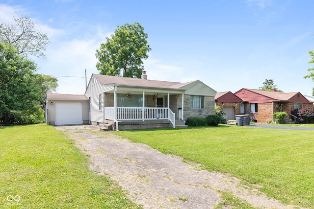 1020 N Ritter Ave, Indianapolis, IN 46219 - view of front facade with a porch, a garage, a front yard, and asphalt driveway