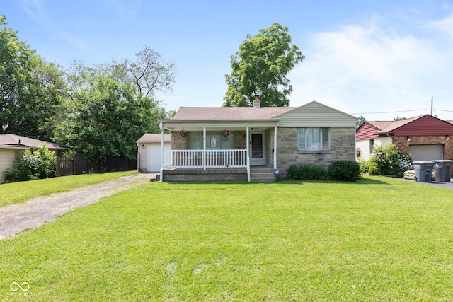 1020 N Ritter Ave, Indianapolis, IN 46219 - view of front of property featuring a porch, stone siding, a garage, an outdoor structure, and driveway