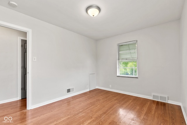 1020 N Ritter Ave, Indianapolis, IN 46219 - empty room with a smoke detector and light wood-style flooring
