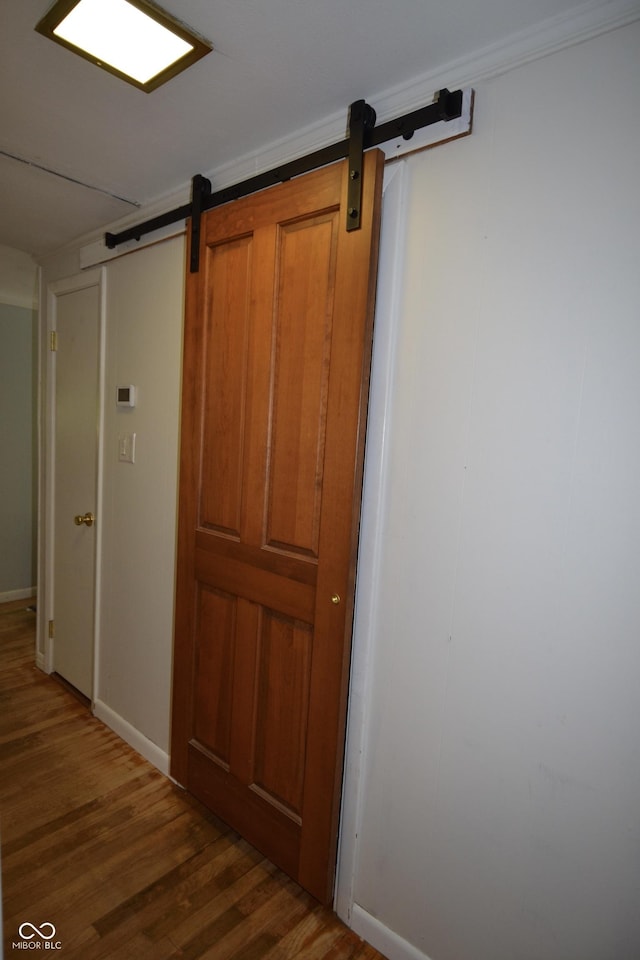 7150 Combs Rd, Indianapolis, IN 46237 - corridor with a barn door and wood finished floors