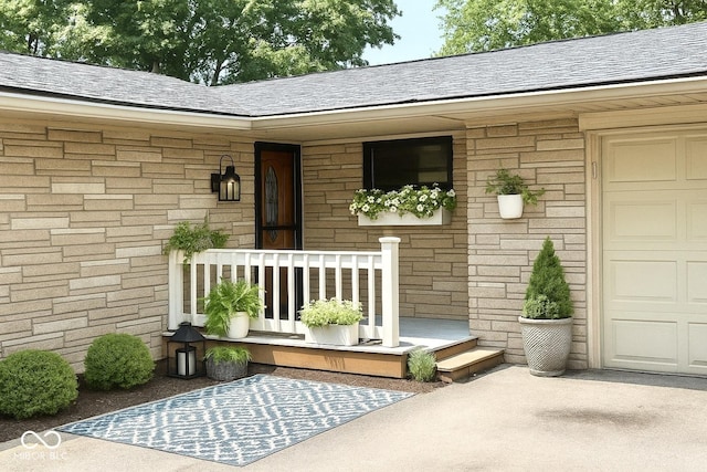 7150 Combs Rd, Indianapolis, IN 46237 - doorway to property with driveway, roof with shingles, and an attached garage
