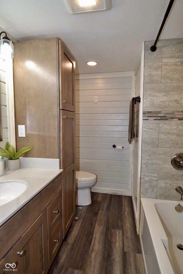 7150 Combs Rd, Indianapolis, IN 46237 - full bathroom with vanity, wood finished floors, shower / washtub combination, and recessed lighting