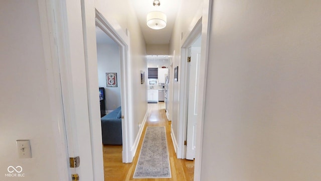 1002 N New Jersey St, Indianapolis, IN 46202 - corridor featuring light wood-style flooring and baseboards