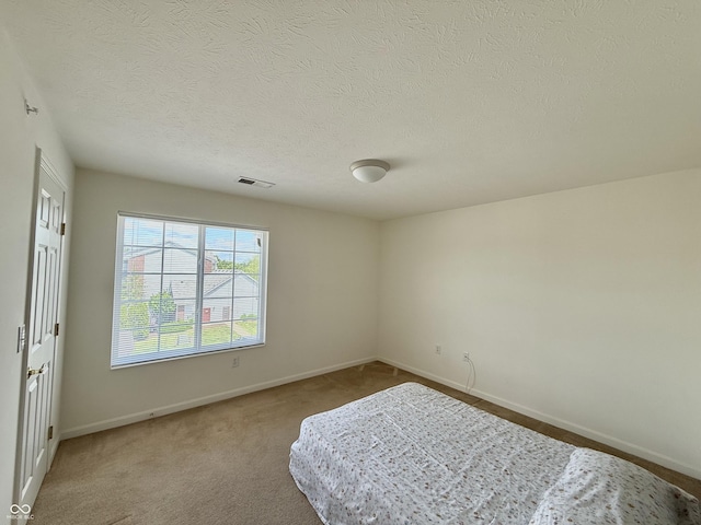 5019 Amber Creek Pl, Indianapolis, IN 46237 - unfurnished bedroom featuring a textured ceiling and carpet