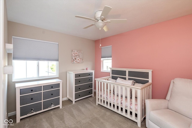 4642 Boyd Pl, Westfield, IN 46062 - bedroom featuring multiple windows, a crib, carpet flooring, and a ceiling fan