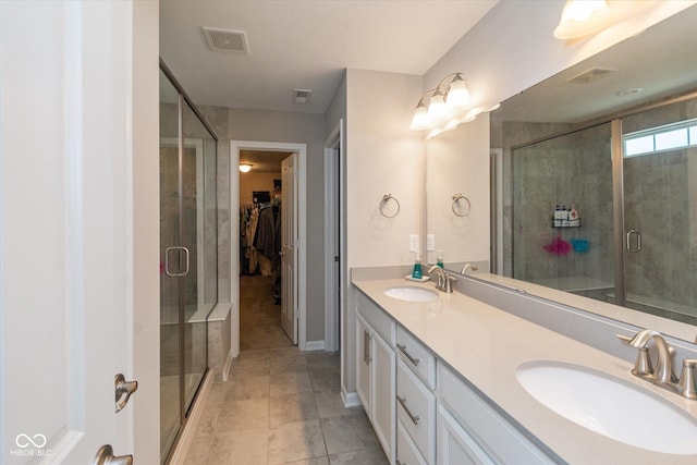 4642 Boyd Pl, Westfield, IN 46062 - full bathroom with a stall shower, double vanity, a spacious closet, and tile patterned flooring