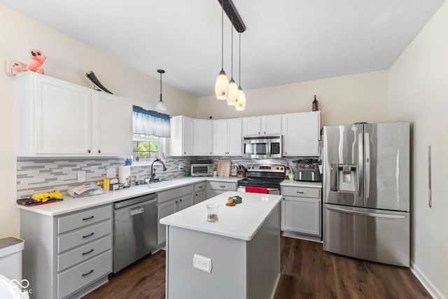 6563 Enclave Blvd, Greenwood, IN 46143 - kitchen with appliances with stainless steel finishes, backsplash, dark wood finished floors, and light countertops
