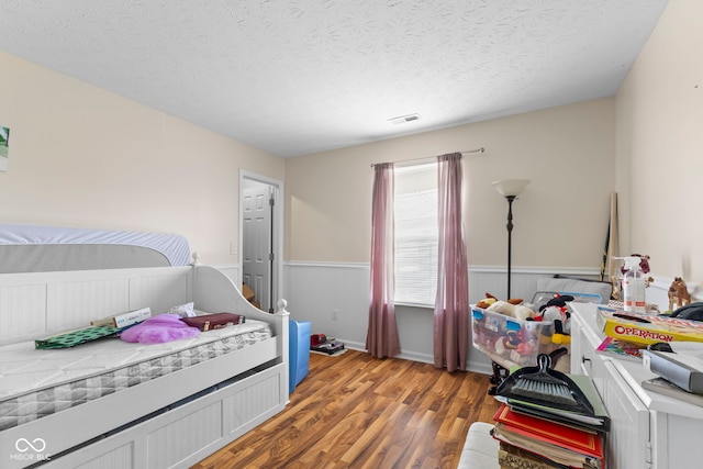 6563 Enclave Blvd, Greenwood, IN 46143 - bedroom featuring light wood-style flooring and a textured ceiling
