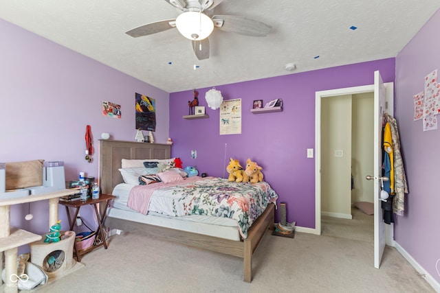 6563 Enclave Blvd, Greenwood, IN 46143 - bedroom with light carpet, ceiling fan, and a textured ceiling
