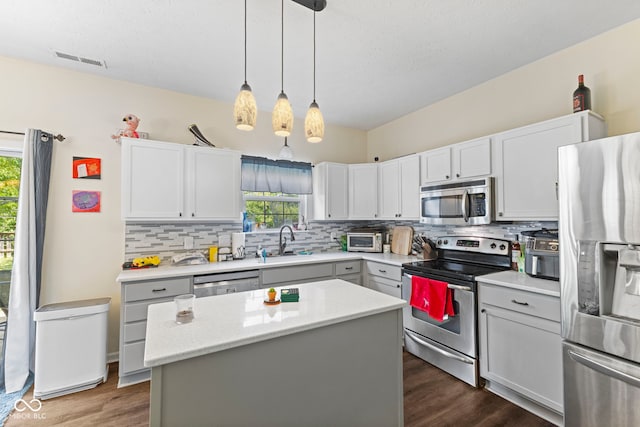 6563 Enclave Blvd, Greenwood, IN 46143 - kitchen featuring appliances with stainless steel finishes, plenty of natural light, dark wood-style floors, and decorative backsplash