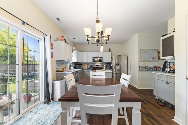 6563 Enclave Blvd, Greenwood, IN 46143 - dining space featuring a chandelier and dark wood-style flooring