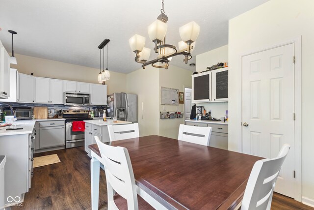 6563 Enclave Blvd, Greenwood, IN 46143 - dining area featuring a chandelier and dark wood-type flooring