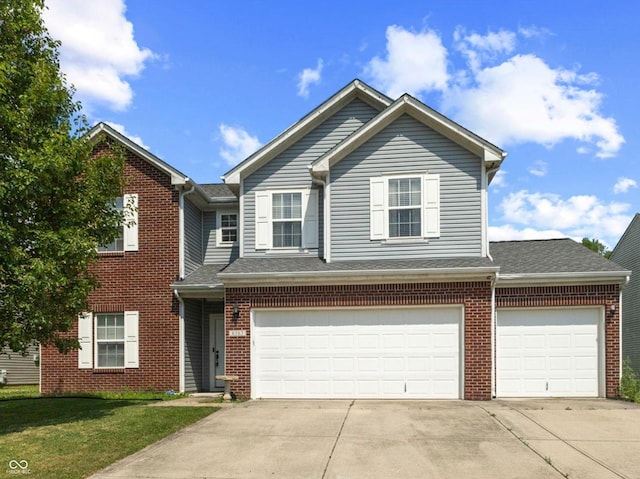 6563 Enclave Blvd, Greenwood, IN 46143 - view of front of property featuring driveway, an attached garage, and brick siding