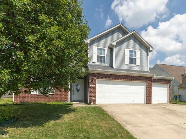 6563 Enclave Blvd, Greenwood, IN 46143 - view of front of home with brick siding, a front lawn, driveway, and an attached garage