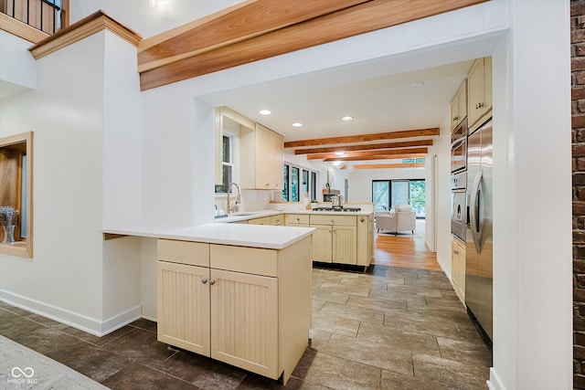1065 E 76th St, Indianapolis, IN 46240 - kitchen with a peninsula, cream cabinets, recessed lighting, beam ceiling, and stone tile floors