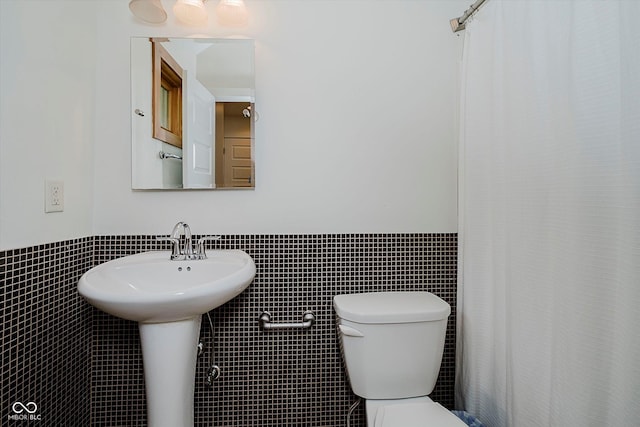 1065 E 76th St, Indianapolis, IN 46240 - full bath with tile walls, a wainscoted wall, and a shower with curtain