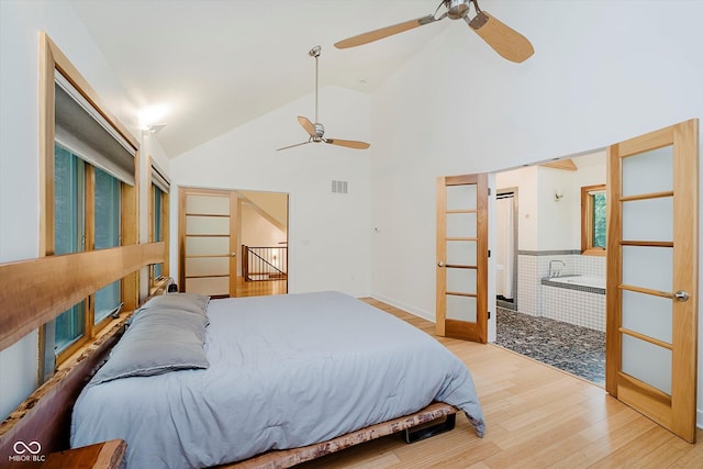 1065 E 76th St, Indianapolis, IN 46240 - bedroom with wood finished floors, high vaulted ceiling, ensuite bath, and a ceiling fan