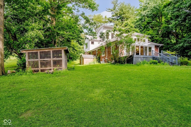 1065 E 76th St, Indianapolis, IN 46240 - view of grassy yard featuring an outbuilding and a wooden deck