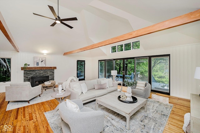 1065 E 76th St, Indianapolis, IN 46240 - living area featuring high vaulted ceiling, plenty of natural light, ceiling fan, a stone fireplace, and wood-type flooring