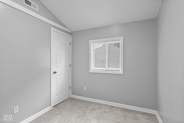 1254 Wade St, Austin, IN 47102 - unfurnished bedroom featuring light colored carpet and vaulted ceiling