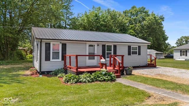 1254 Wade St, Austin, IN 47102 - bungalow-style house with a wooden deck, a metal roof, and a front lawn