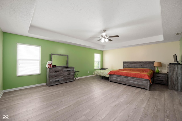 1312 Donald Pass, Greenwood, IN 46143 - bedroom featuring a raised ceiling, wood finished floors, ceiling fan, and a textured ceiling