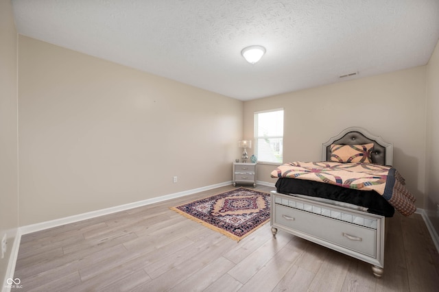 1312 Donald Pass, Greenwood, IN 46143 - bedroom featuring wood finished floors and a textured ceiling