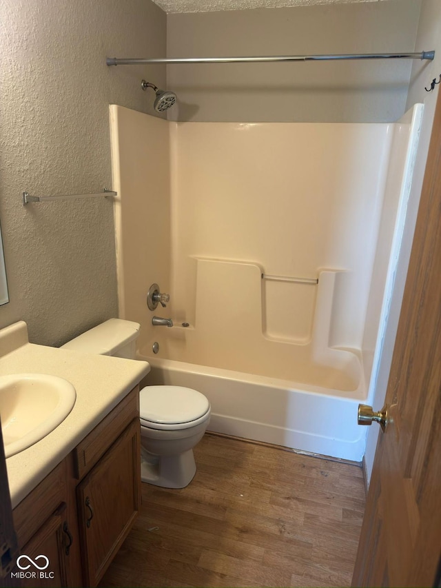 39 Meadow Creek E Boulevard, Whiteland, IN 46184 - bathroom with vanity, a textured wall, wood finished floors, and washtub / shower combination