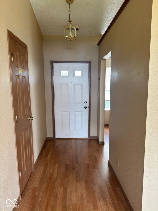 39 Meadow Creek E Boulevard, Whiteland, IN 46184 - doorway with wood finished floors, a textured ceiling, and a chandelier