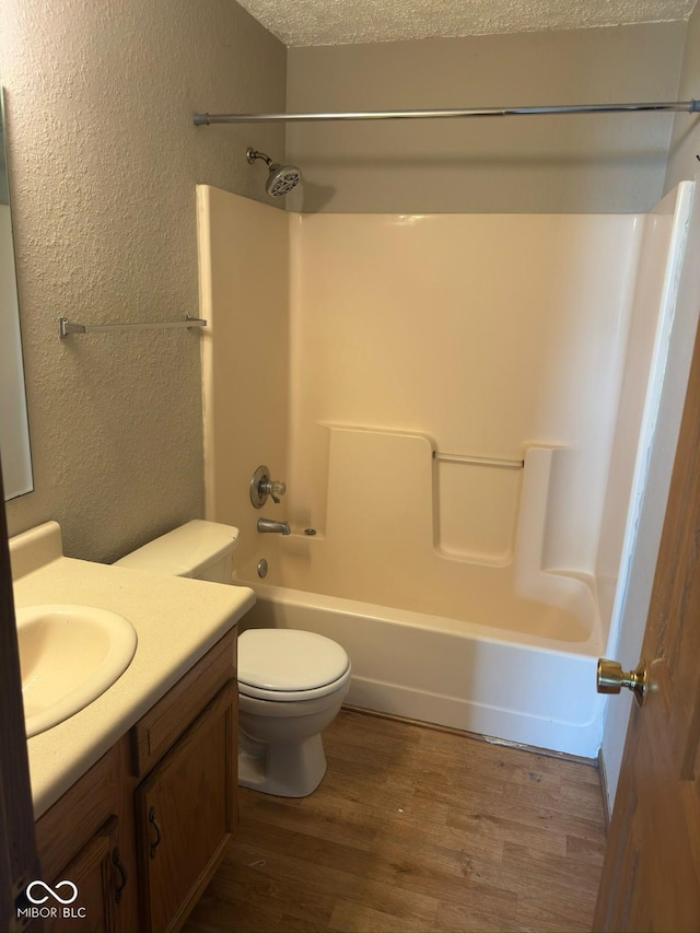39 Meadow Creek E Boulevard, Whiteland, IN 46184 - bathroom featuring a textured wall, vanity, wood finished floors, and tub / shower combination