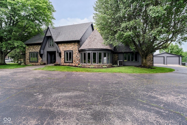 16714 Oak Rd, Westfield, IN 46074 - view of front facade featuring stone siding, an outbuilding, a garage, and a front yard