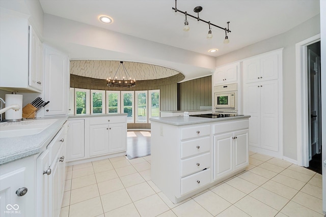 16714 Oak Rd, Westfield, IN 46074 - kitchen featuring a chandelier, light tile patterned floors, light countertops, and white cabinets