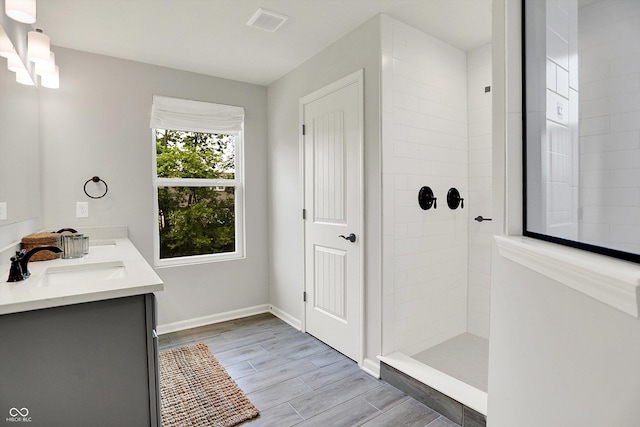 2074 Tompkins Dr, Westfield, IN 46074 - full bath featuring double vanity, a tile shower, and wood finished floors