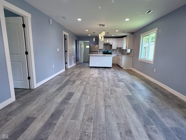 1818 Broadway St, Anderson, IN 46012 - kitchen featuring freestanding refrigerator, recessed lighting, open floor plan, wood finished floors, and white cabinetry