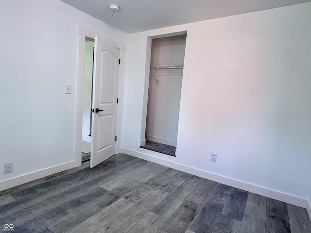 1818 Broadway St, Anderson, IN 46012 - unfurnished bedroom with dark wood-type flooring and a closet