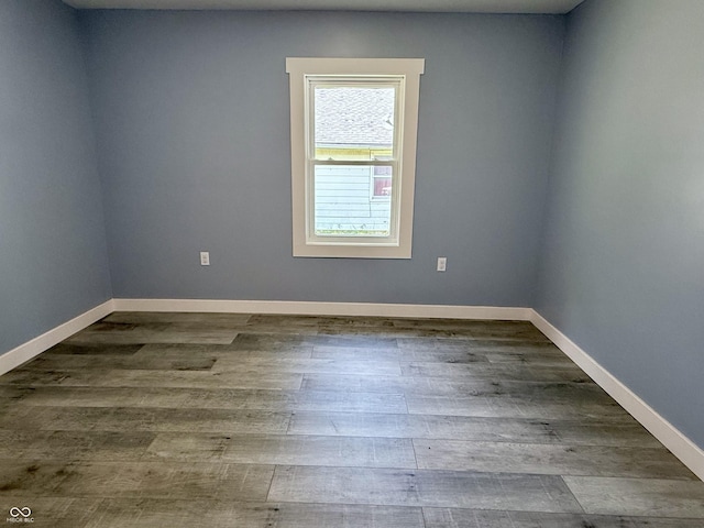 1818 Broadway St, Anderson, IN 46012 - empty room featuring dark wood-style floors and baseboards